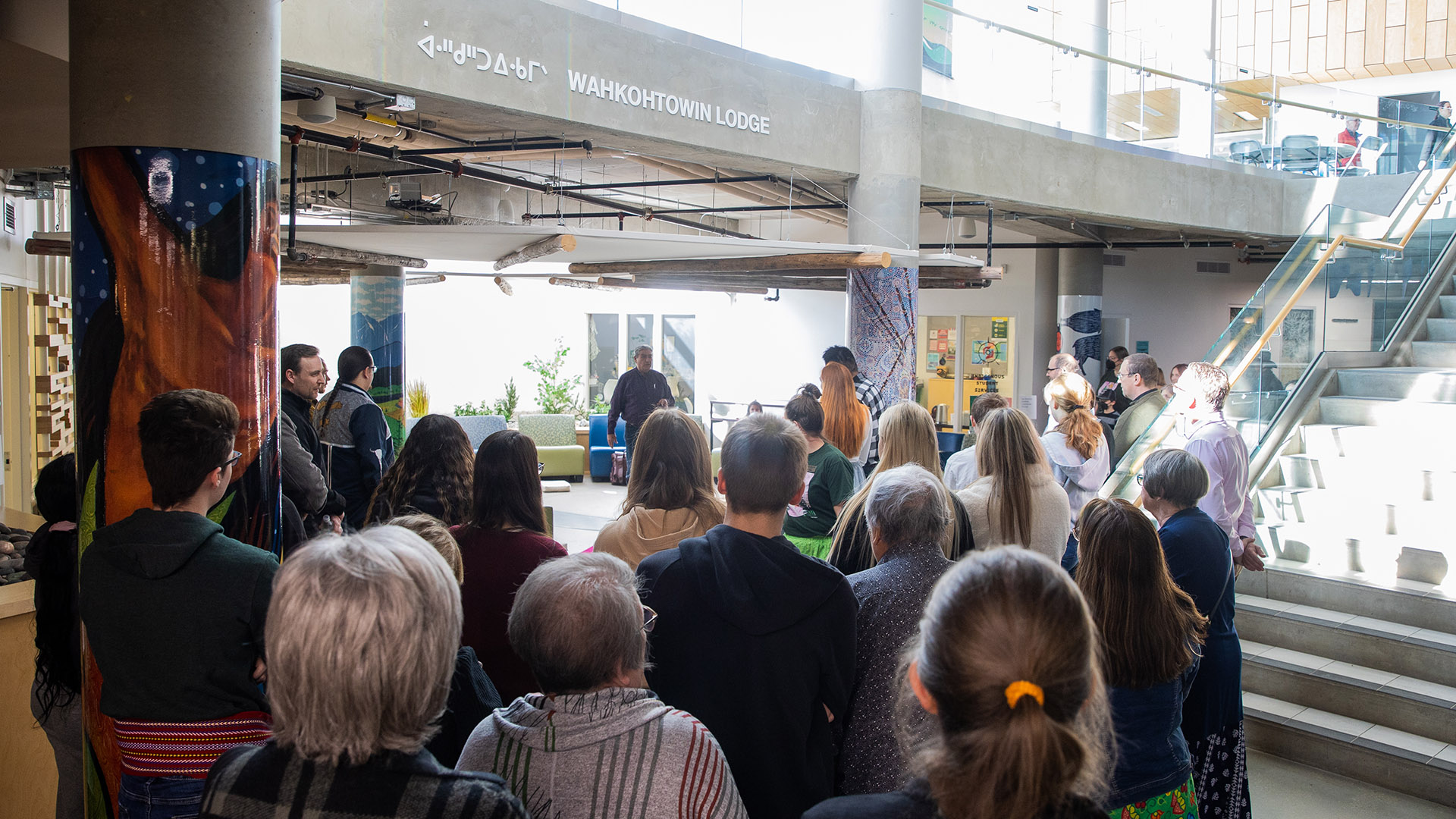 A group of people gathered in Augustana's wahkohtowin Lodge to celebrate the seventh anniversary.