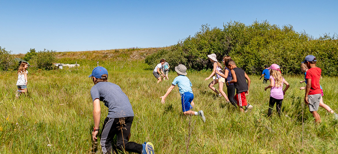 Kids running and playing in a field