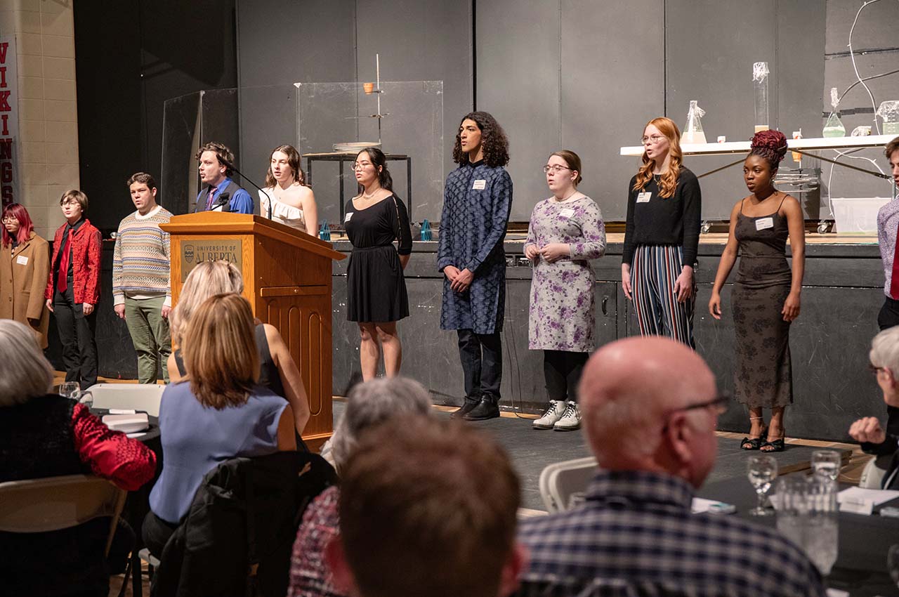 Augustana Choir members performing in the gymnasium