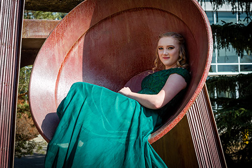 Alexandra Brigley posing inside the graduation bell