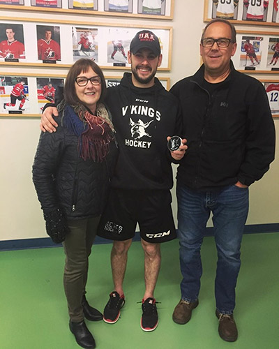 Curtis Skip posing beside his parents, Al and Jean