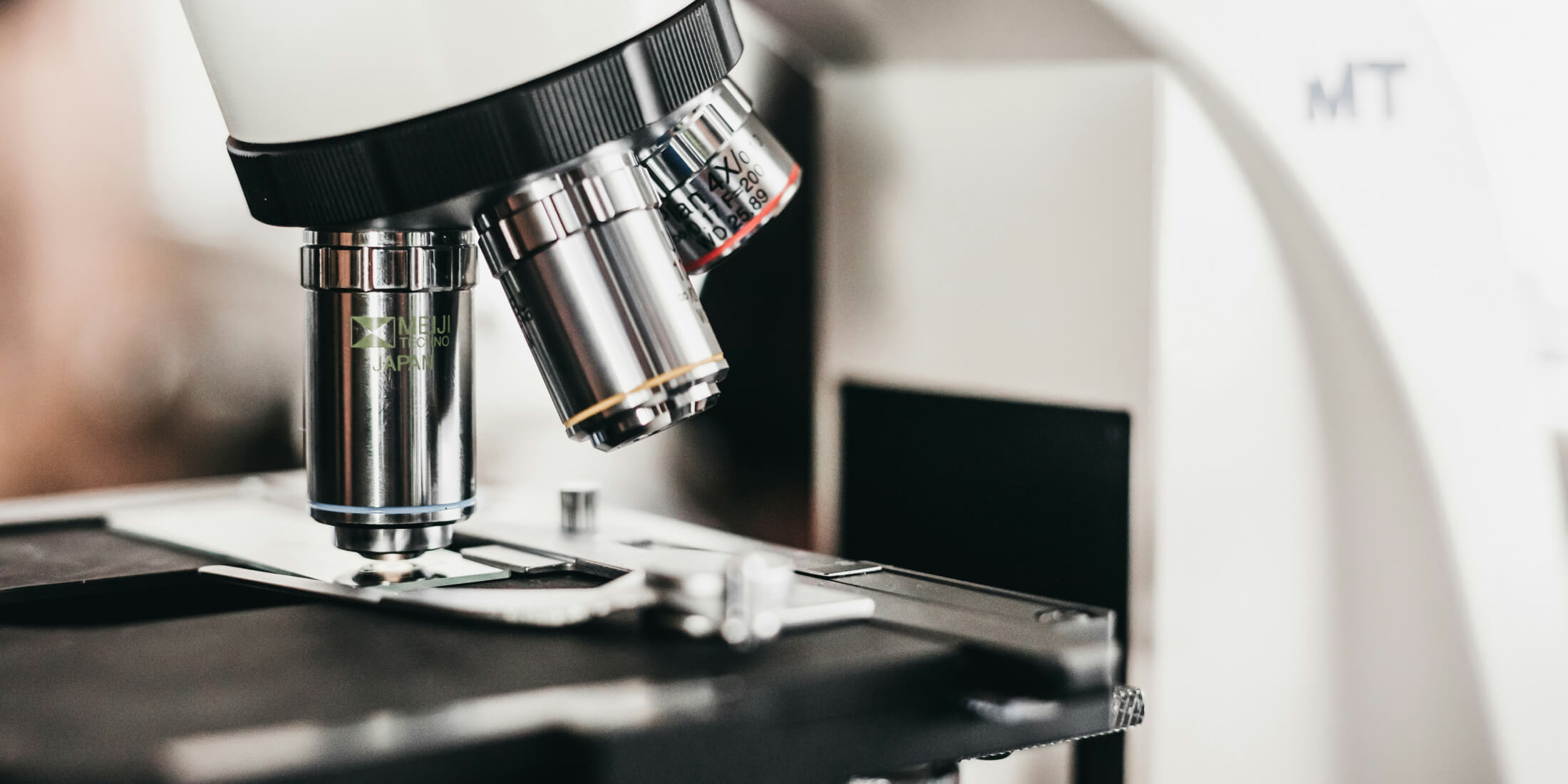 Microscope objective lenses focused on a glass slide.
