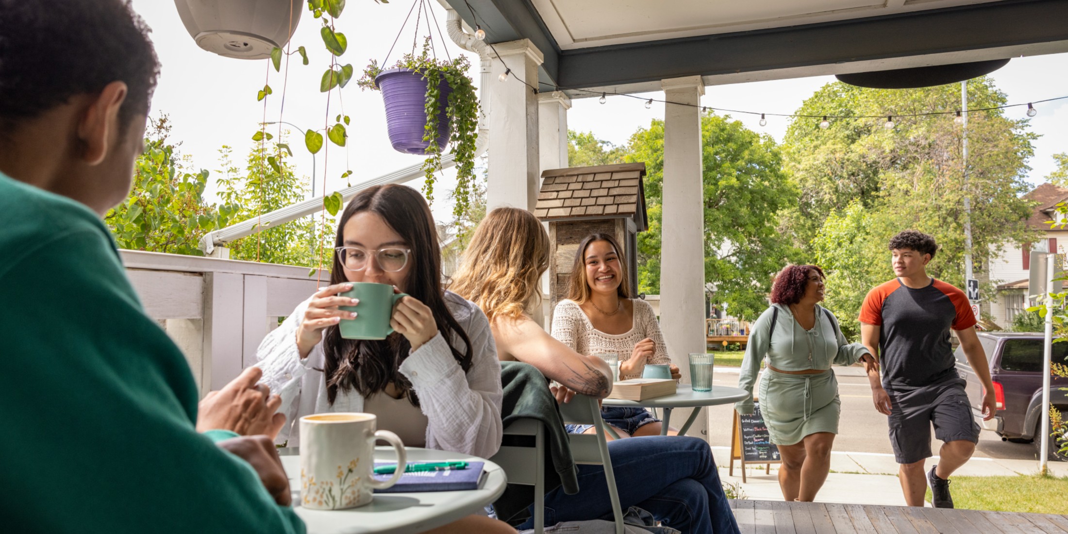 People enjoying coffee on a porch cafe