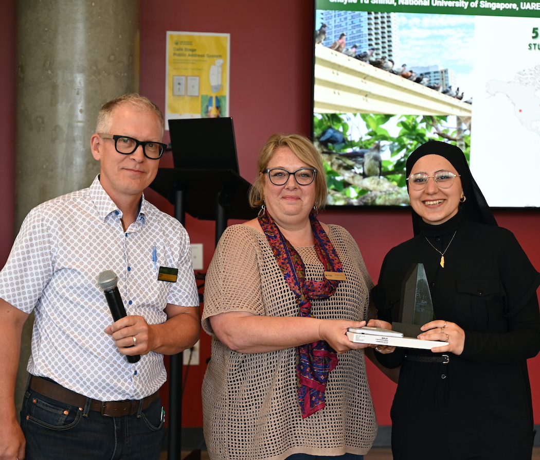 Rama Taha, winner of the 2024 Three Minute Thesis competition, alongside dean John Parkins and professor Sandra Rein