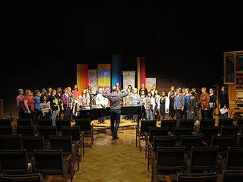 A photo of a choir director leading a choir
