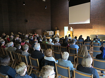 The chapel filled with people listening to a speaker