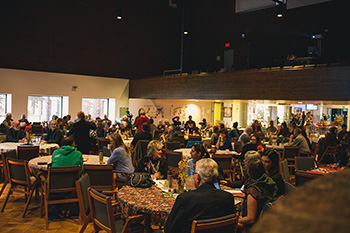 The chapel filled with people sitting at conference tables