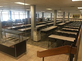A wide shot of the entire dining hall, with no people.