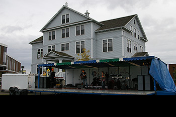 A photo of a sound stage set up and performers playing music.