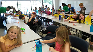 A photo of children working at a craft at tables