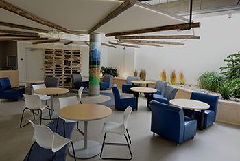 A photo of tables and chairs placed in Wahkohtowin Lodge