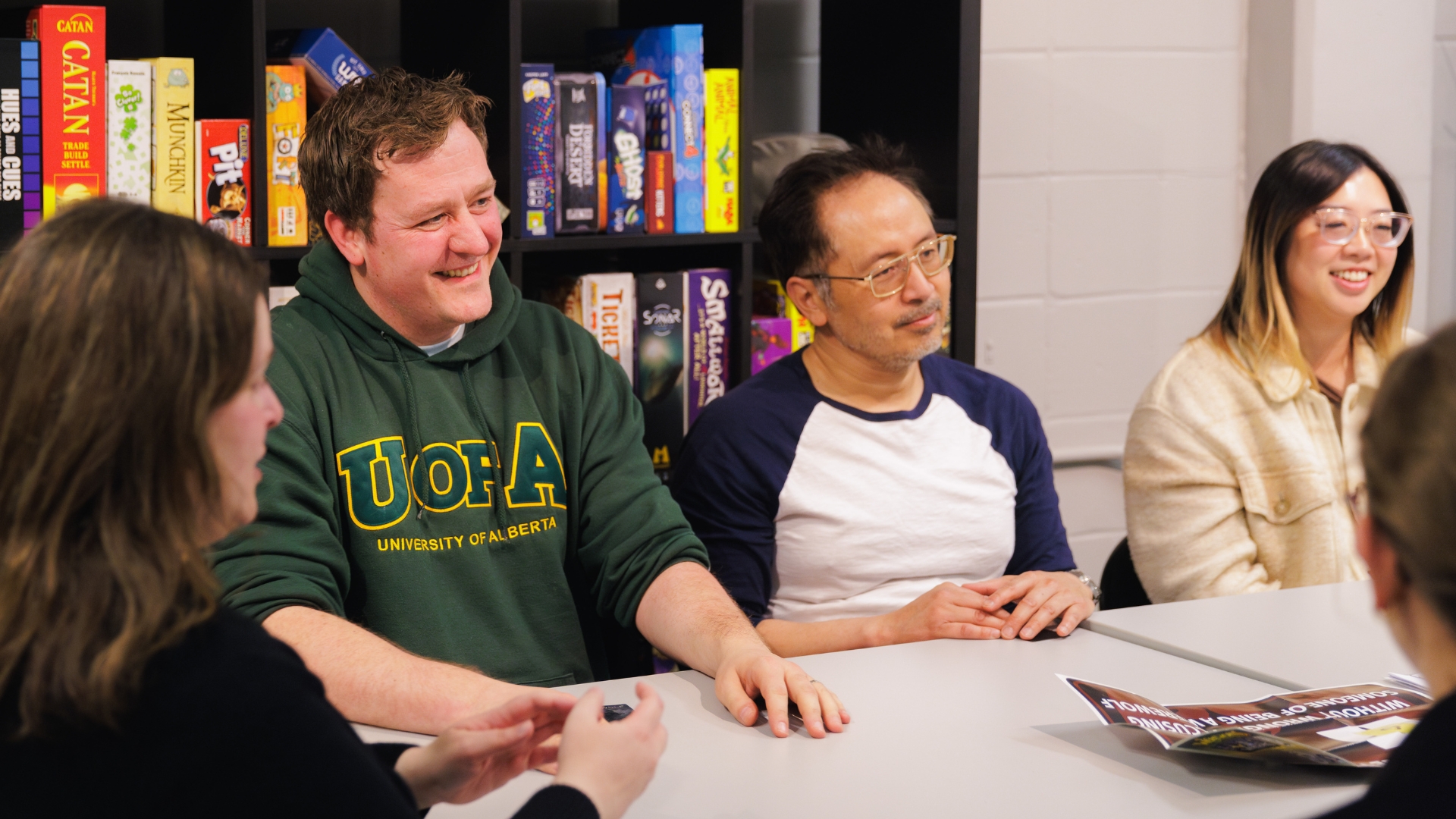 A group of employees sitting around a table engaging in a team building activity