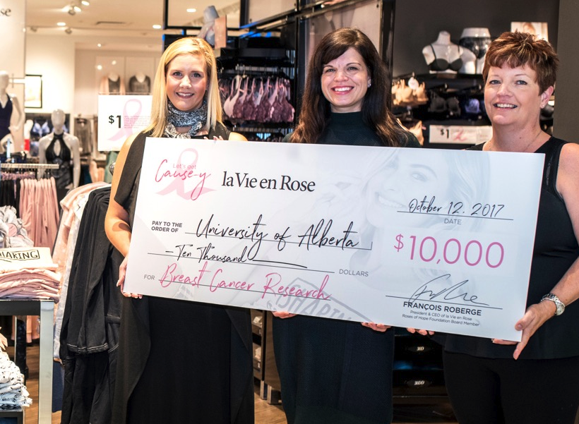 Lynne-Marie Postovit accepts La Vie en Rose cheque for studentships