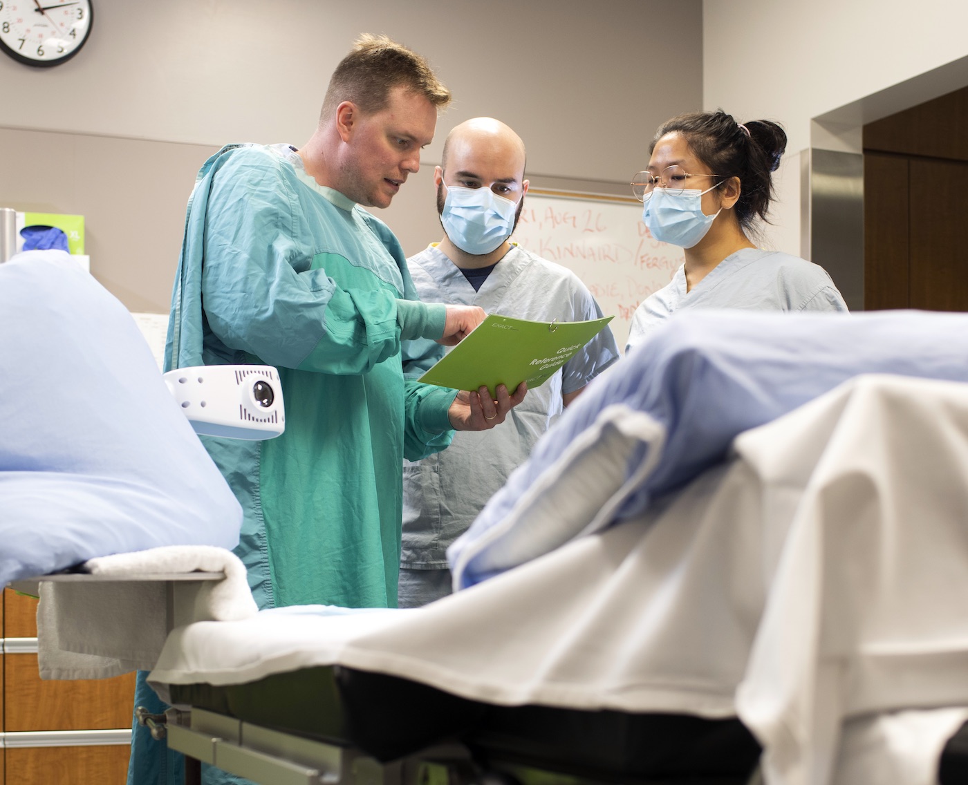 Adam Kinnaird and assistants around a hospital bed