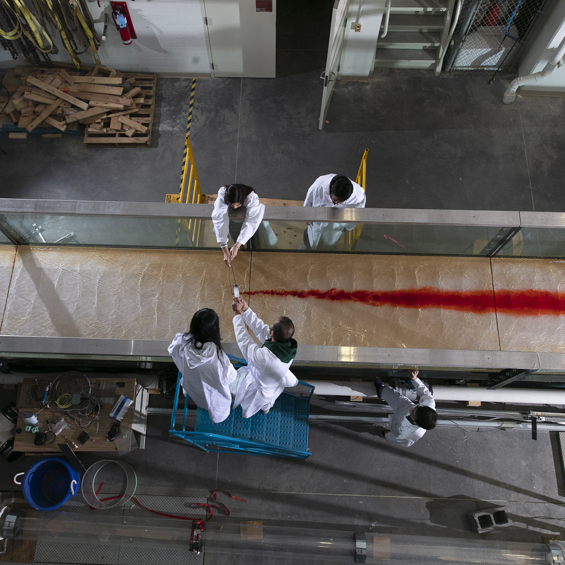 Grad students studying water flow in a lab