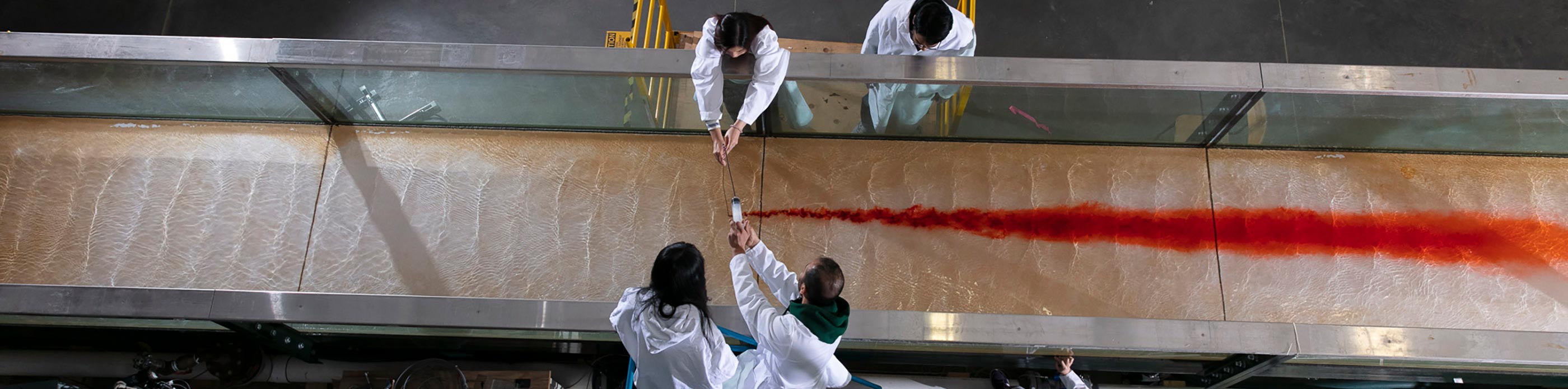Grad students studying water flow in a lab