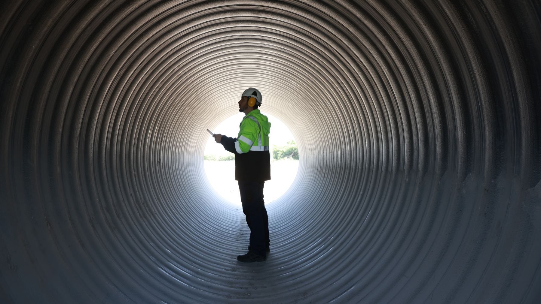 Man in reflective vest standing in tunnel