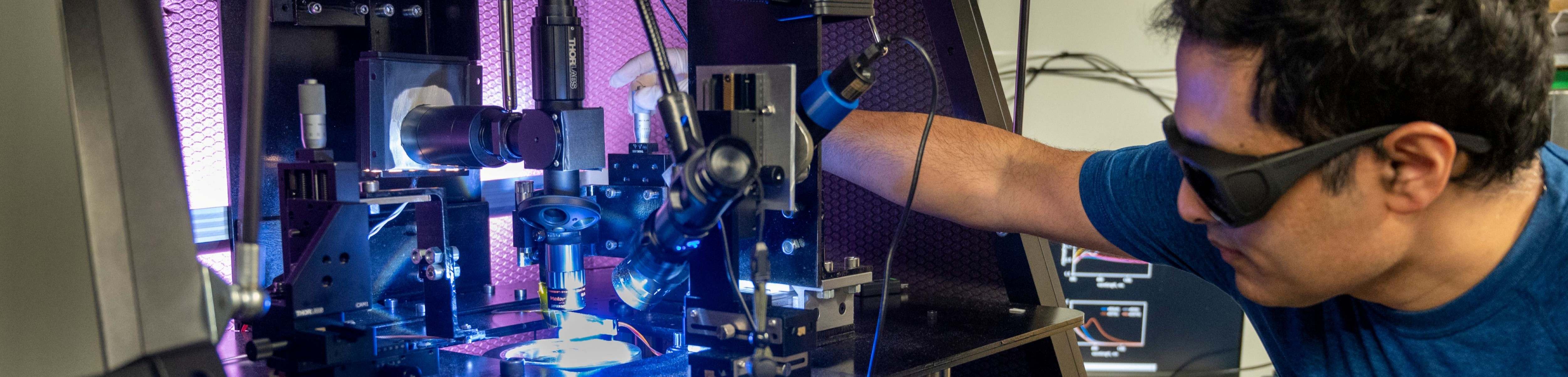 Engineering student using microscope