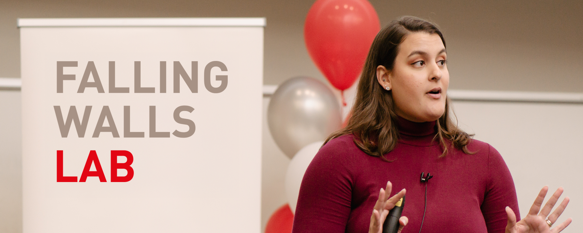 Woman holding up hand and talking into mic