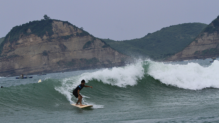 Mudher surfing in Lombok, Indonesia