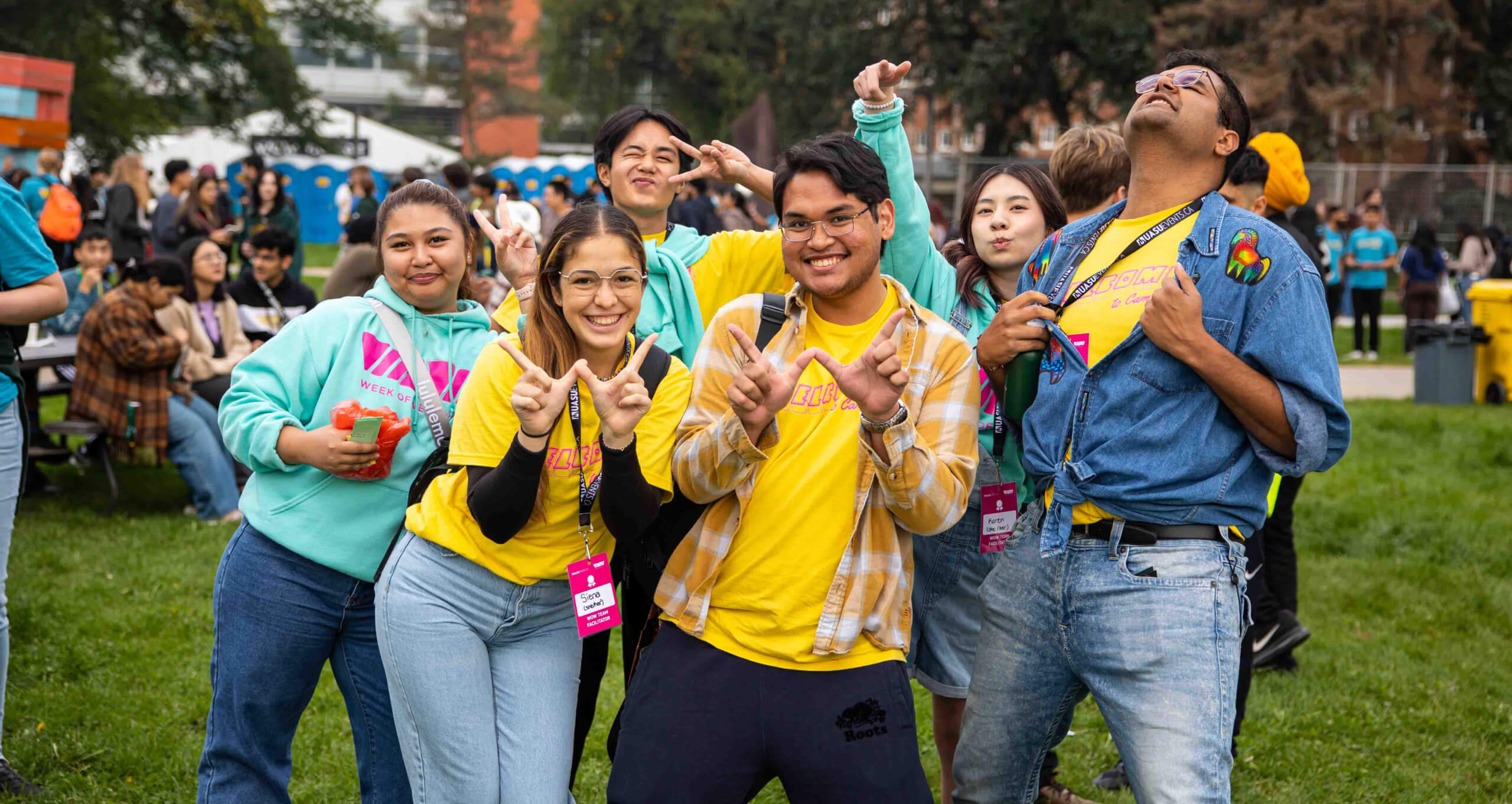 U of A students at the WOW Village making 'W' with their hands