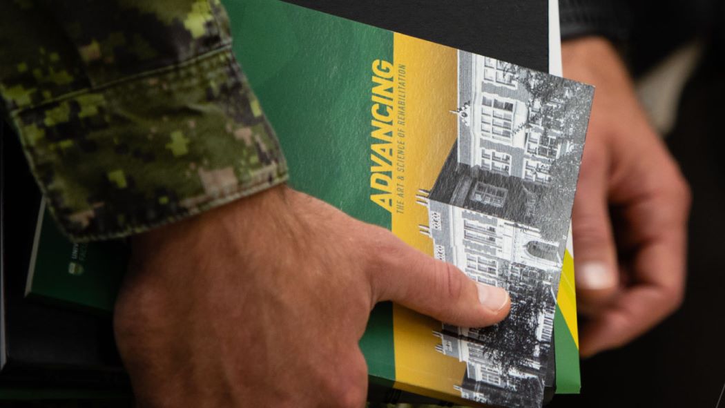 Veteran holding books
