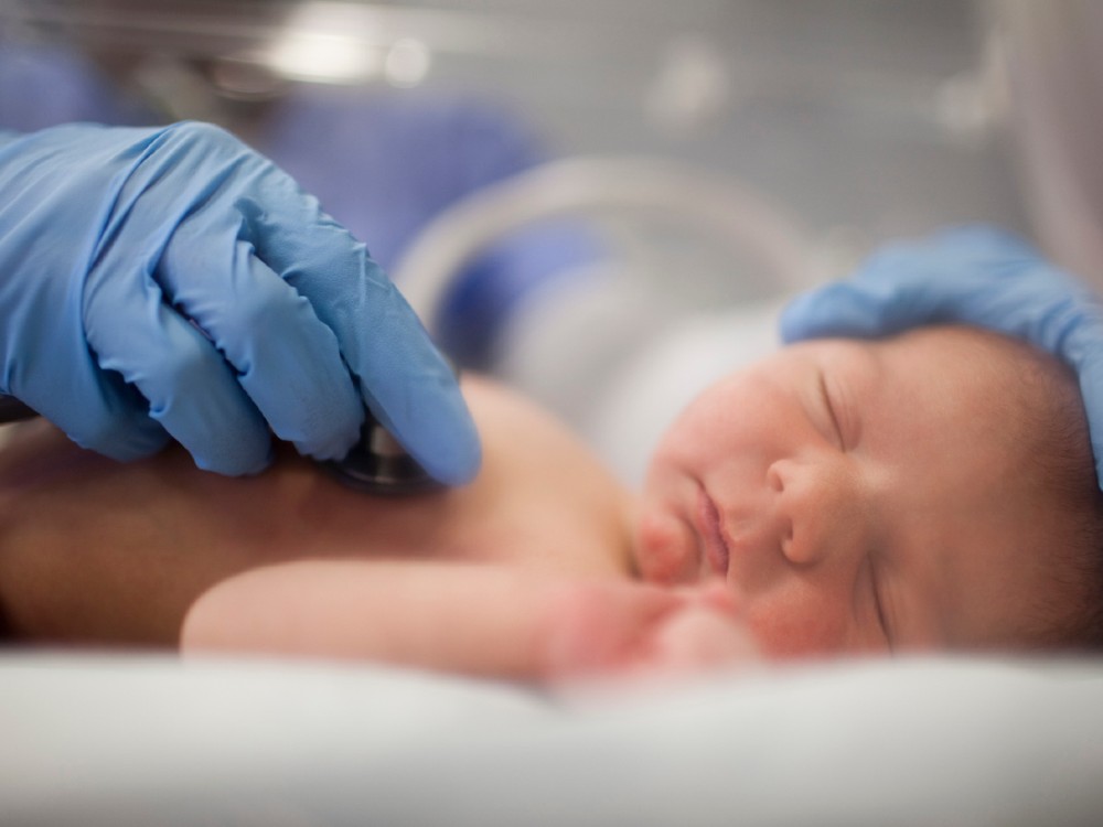 Infant in hospital with stethoscope on chest
