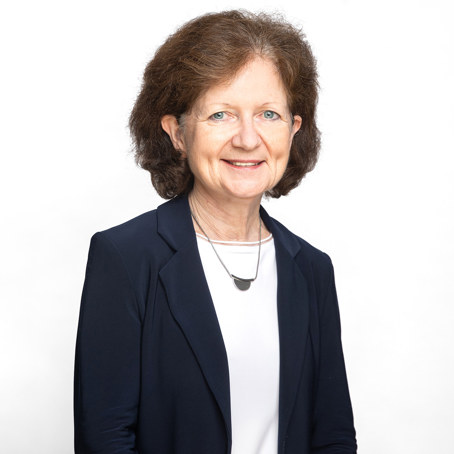 A headshot of Brenda Hemmelgarn, Dean of the Faculty of Medicine & Dentistry, in a sunny pedway.
