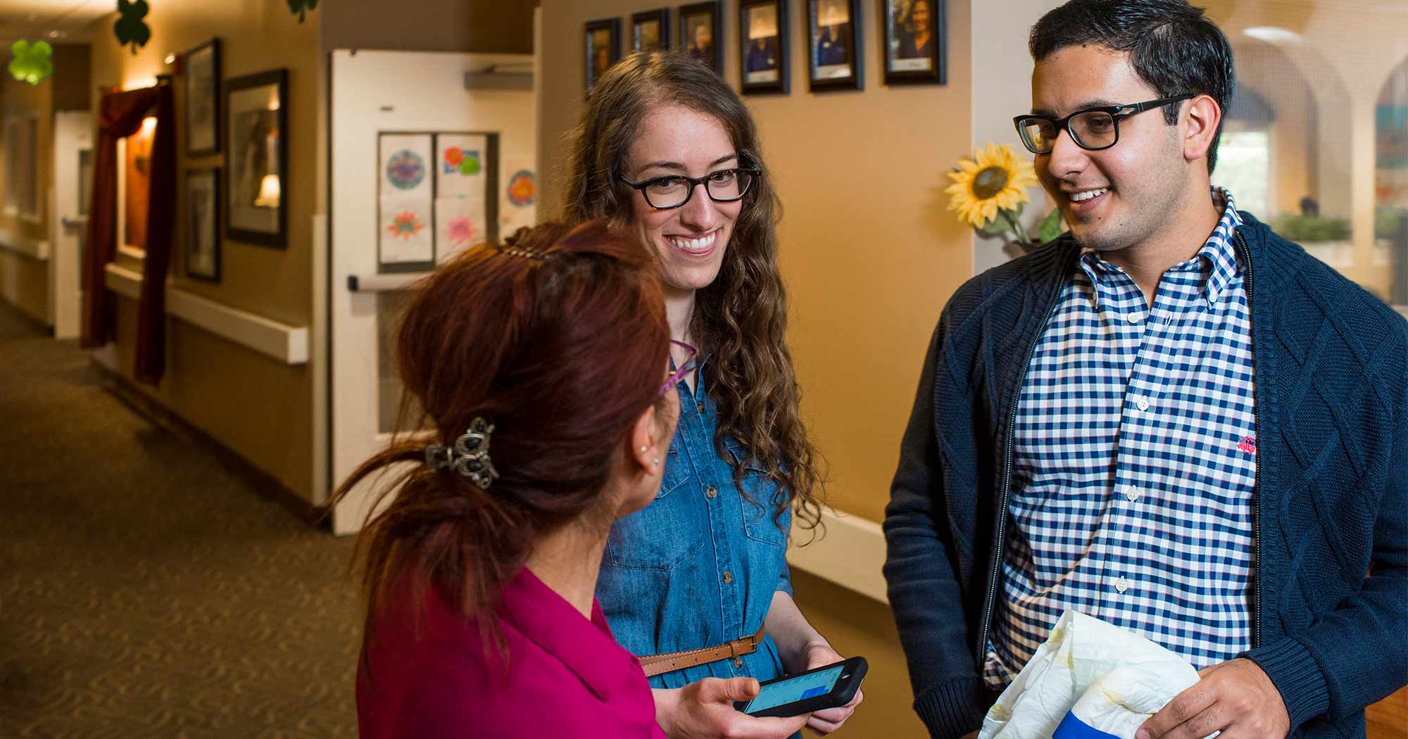A group of students sitting in a library meeting room