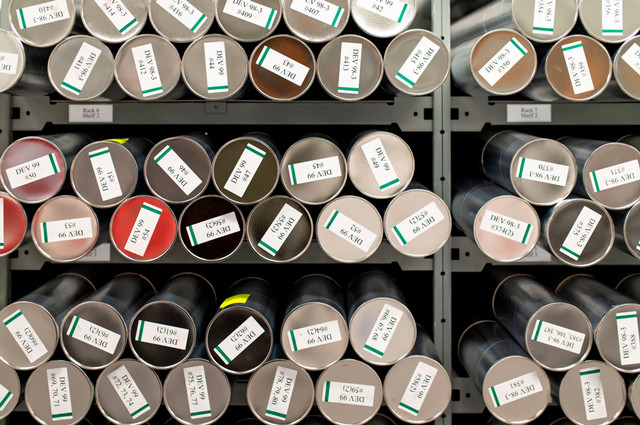 Silver storage tubes containing ice cores on a metal shelf in the Canadian Ice Core Lab