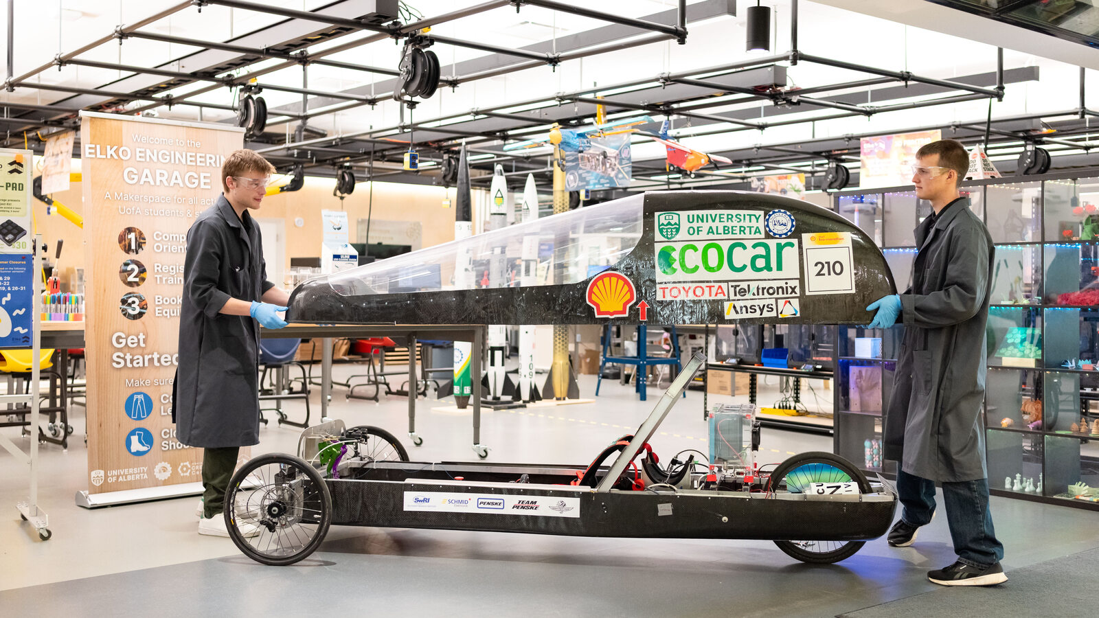 Engineering students move an Eco Car the Engineering Garage.