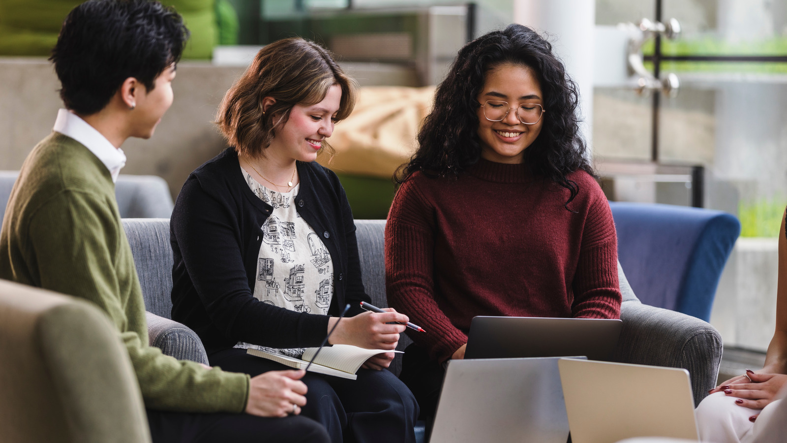 Students chat on the steps of SUB basement with their laptops and study material open.