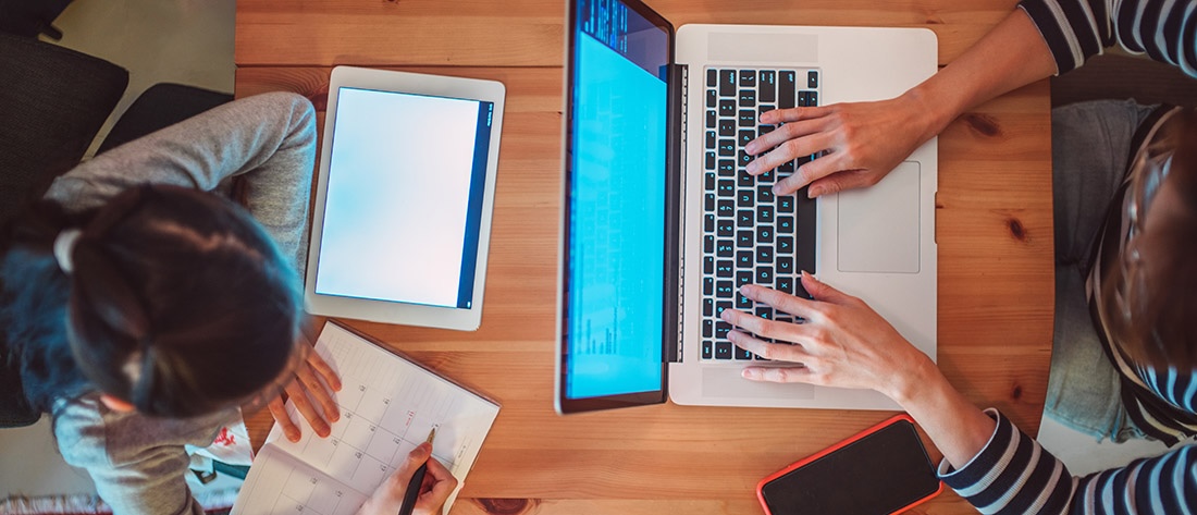 View from above of two students working on assignments