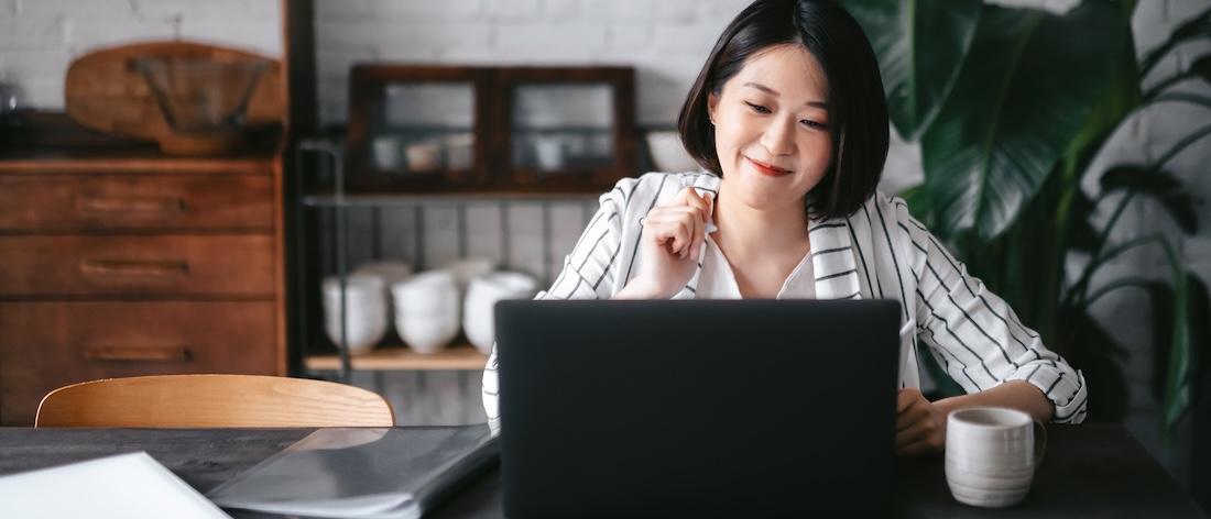 Student smiling at her laptop