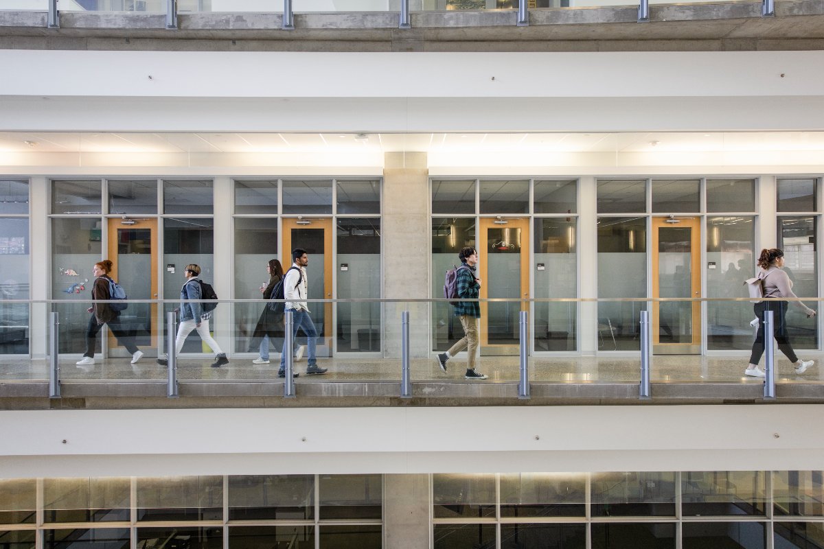 A group of Faculty of Science students walk between labs in the Centennial Centre for Interdisciplinary Science at the University of Alberta.