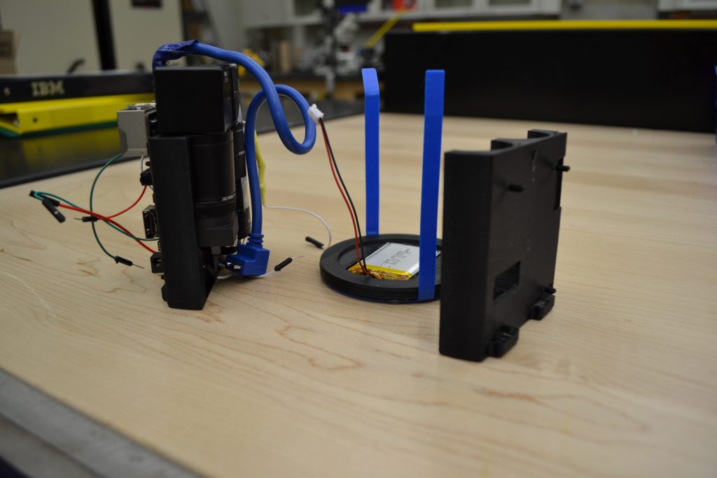 Deconstructed centrifuge microscope assembly with Rock64 computer, optics, camera unit, and battery
